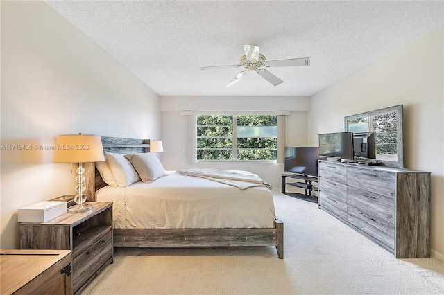 carpeted bedroom with a textured ceiling and ceiling fan