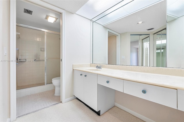 bathroom featuring toilet, vanity, and walk in shower