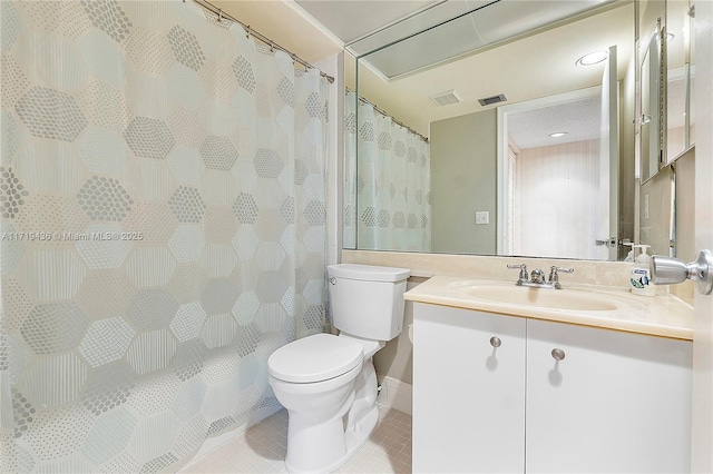 bathroom featuring tile patterned floors, vanity, and toilet