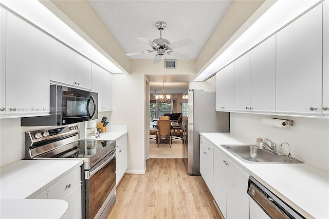 kitchen with white cabinetry, sink, stainless steel appliances, a textured ceiling, and ceiling fan with notable chandelier