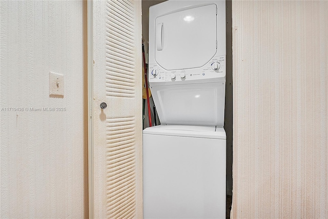 laundry area featuring stacked washer and clothes dryer