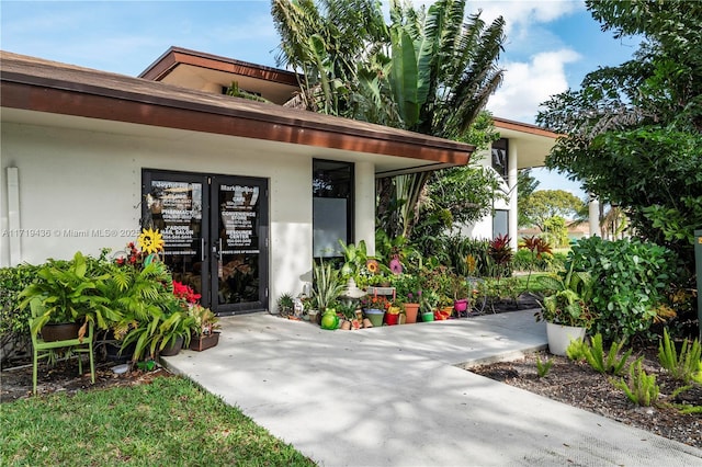 view of exterior entry featuring french doors