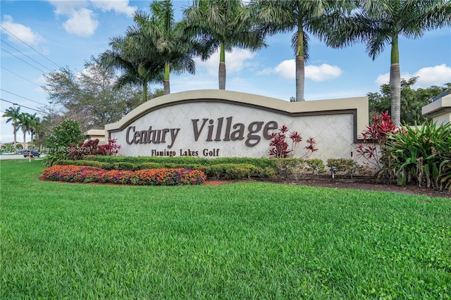 community sign featuring a lawn