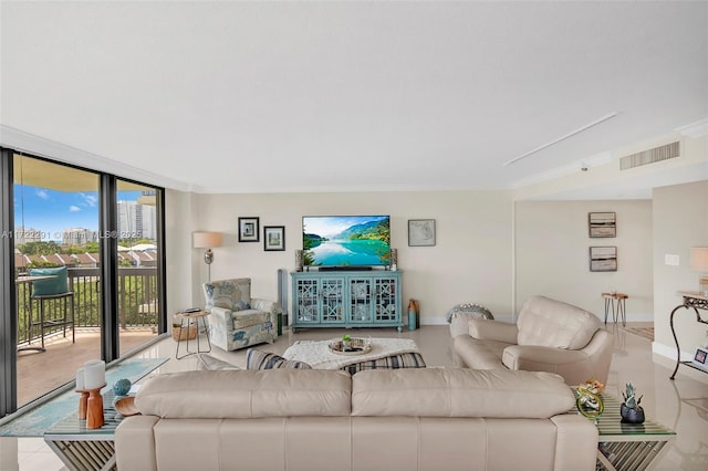 living room with light tile patterned floors, floor to ceiling windows, and crown molding