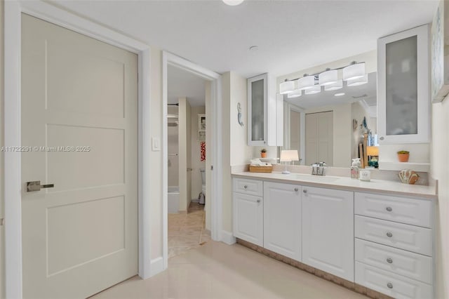 bathroom featuring toilet, vanity, and tile patterned floors