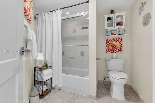 bathroom featuring shower / tub combo with curtain, tile patterned flooring, and toilet