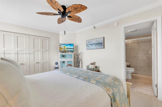 tiled bedroom featuring ensuite bath, ceiling fan, a closet, and ornamental molding