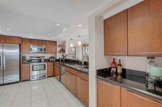 kitchen with pendant lighting, a raised ceiling, sink, light tile patterned floors, and stainless steel appliances