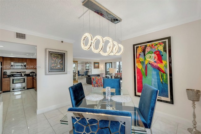 tiled dining area featuring a notable chandelier, a textured ceiling, and ornamental molding