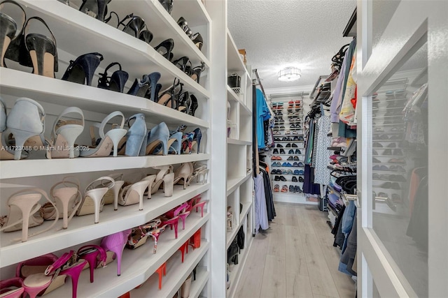 spacious closet featuring light hardwood / wood-style floors