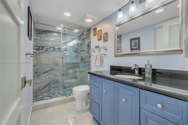 bathroom featuring tile patterned floors, toilet, vanity, and walk in shower