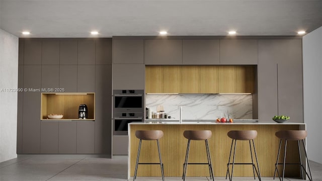 kitchen featuring double oven, built in shelves, a large island, and a kitchen breakfast bar