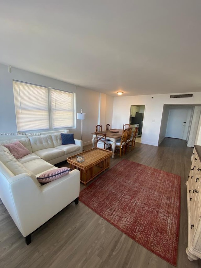 living room with dark hardwood / wood-style flooring