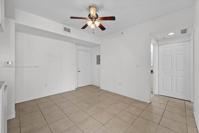 tiled empty room with ceiling fan