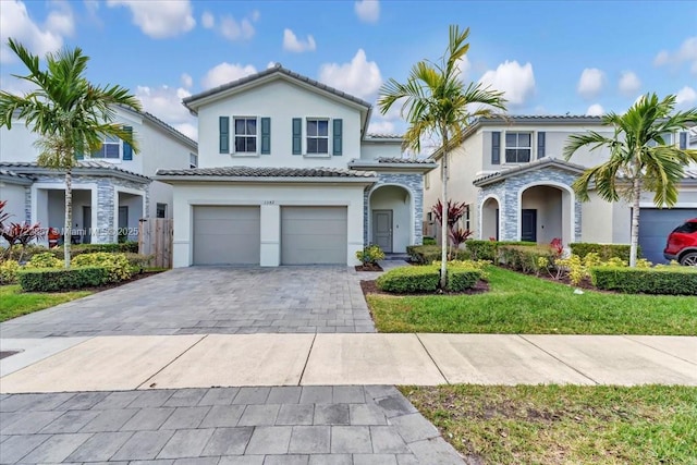 mediterranean / spanish-style home featuring a garage and a front lawn