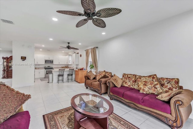 tiled living room featuring ceiling fan