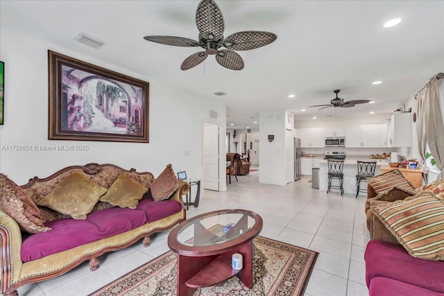 tiled living room with ceiling fan