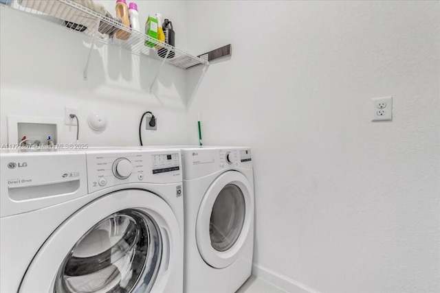 clothes washing area featuring washing machine and dryer