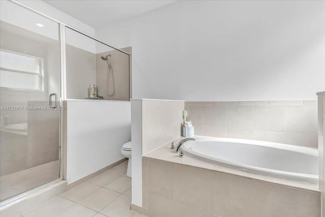 bathroom with tile patterned floors, shower with separate bathtub, and toilet