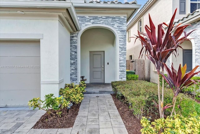 view of exterior entry with a garage