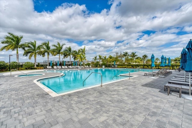 view of pool featuring a patio and a hot tub