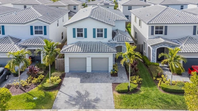 mediterranean / spanish-style house with a front lawn and a garage