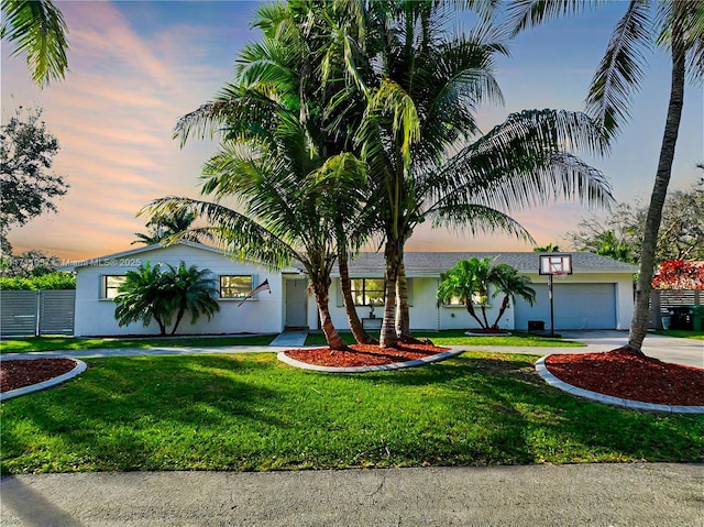 view of front of home with a yard and a garage