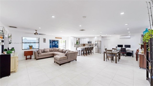 tiled living room featuring ceiling fan and a wall unit AC