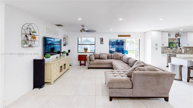 tiled living room featuring ceiling fan