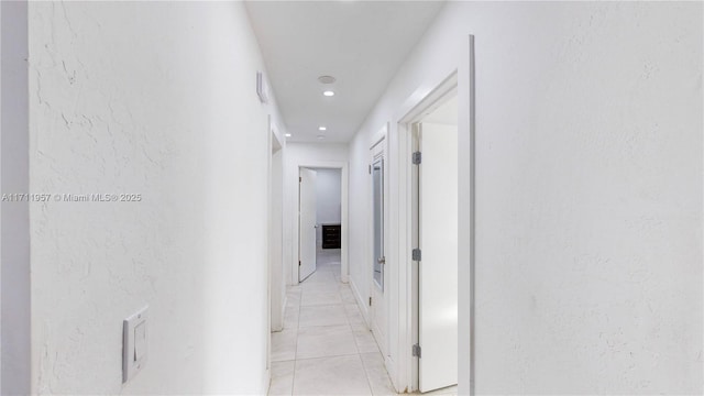 hall with light tile patterned floors