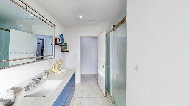 bathroom featuring tile patterned floors, vanity, and walk in shower