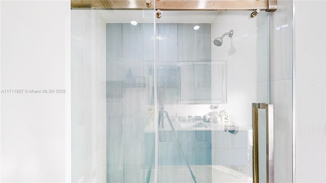 bathroom with a shower with door