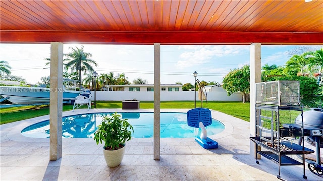 view of swimming pool with a patio and a lawn