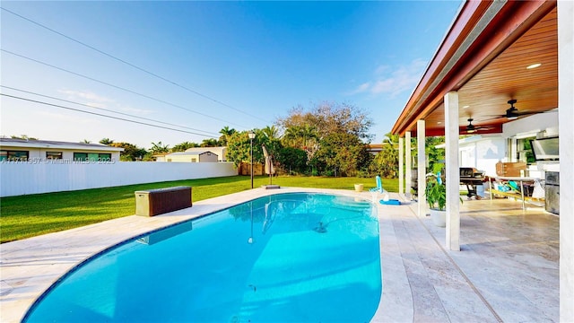 view of swimming pool featuring a yard and a patio area