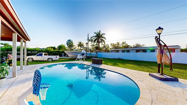 view of pool with a yard and a patio