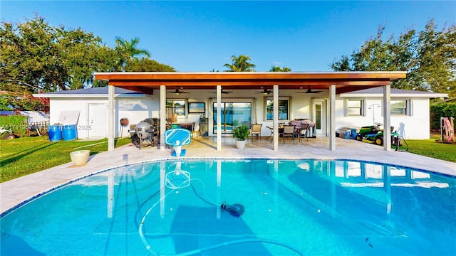 view of swimming pool with ceiling fan and a patio area