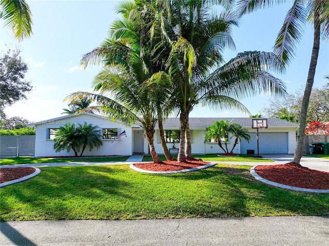 view of front of house with a front yard and a garage