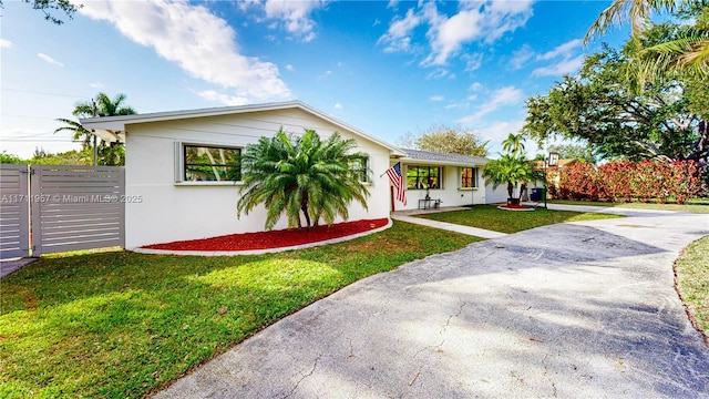 ranch-style home with a front lawn