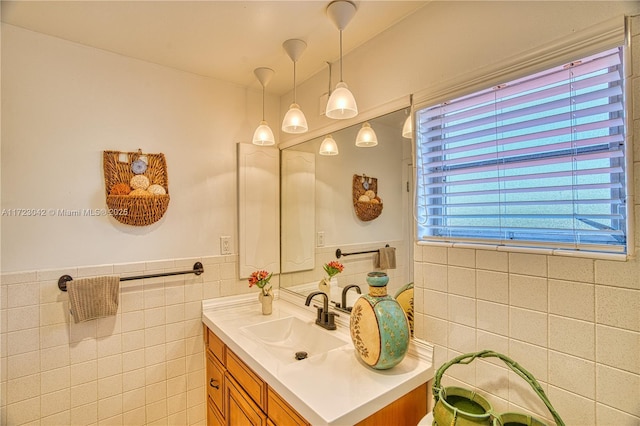 bathroom with tile walls, wainscoting, and vanity