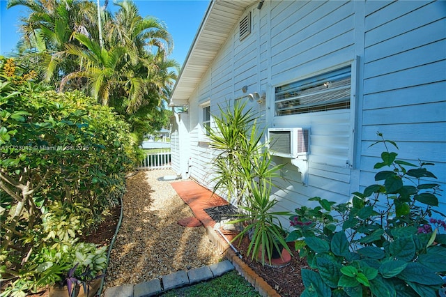 view of home's exterior featuring cooling unit and fence