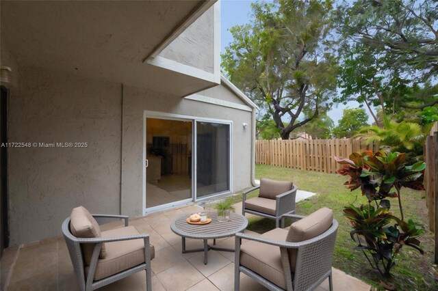 back of property featuring a balcony, a yard, and a patio