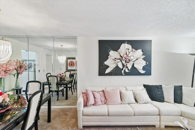 carpeted living room featuring a textured ceiling