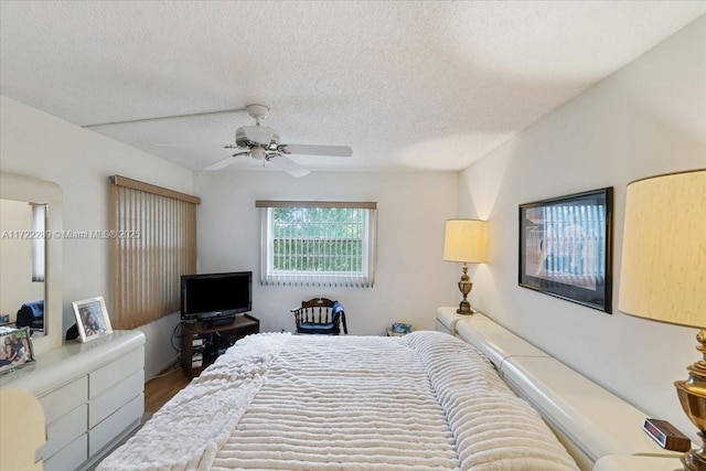 bedroom with a textured ceiling and ceiling fan