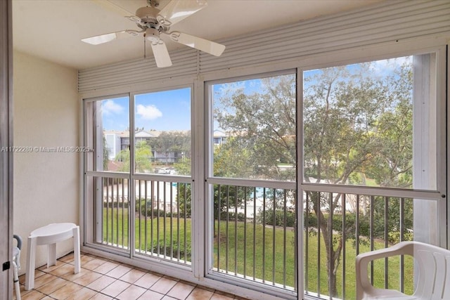 sunroom / solarium featuring a wealth of natural light and ceiling fan