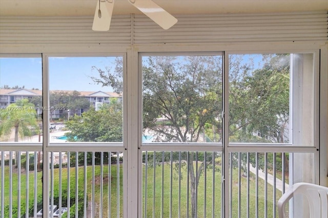 unfurnished sunroom with ceiling fan and a healthy amount of sunlight