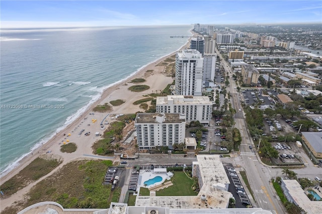 birds eye view of property featuring a beach view and a water view