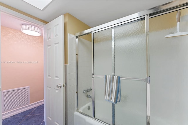 bathroom featuring enclosed tub / shower combo and tile patterned flooring