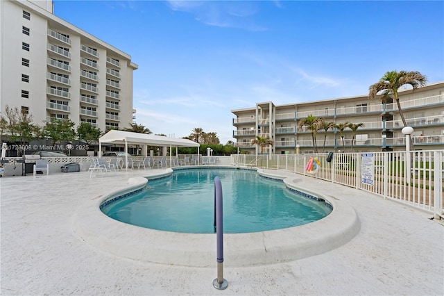 pool featuring a patio and fence