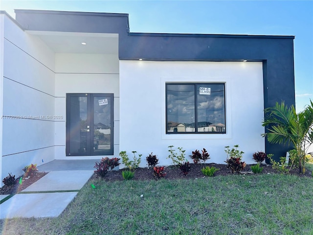 view of front of home featuring french doors and a front yard