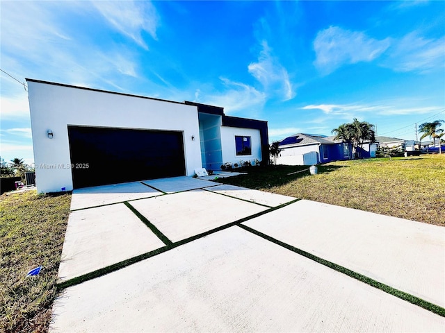 view of front of house featuring a garage and a front lawn